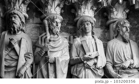 Sculptural images of the Holy Apostles on the wall of the facade of Saint Fin Barre's Cathedral in Cork, Ireland. The Apostles Andrew, James major, Thomas, Matthias. Black and white. Monochrome. Sculptural images of the Holy Apostles on the wall of the facade of Saint Fin Barre's Cathedral in Cork, Ireland. The Apostles Andrew, James major, Thomas, Matthias. Black and white. Monochrome. 103200356