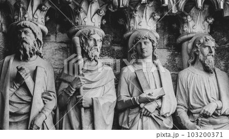 Sculptural images of the Holy Apostles on the wall of the facade of Saint Fin Barre's Cathedral in Cork, Ireland. The Apostles Andrew, James major, Thomas, Matthias. Monochrome. 103200371