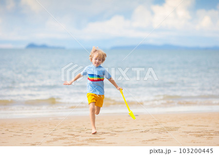 Kids play on tropical beach. Sand and water toy. Kids play on tropical beach. Sand and water toy. 103200445