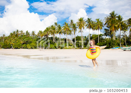 Kids play on tropical beach. Sand and water toy. Kids play on tropical beach. Sand and water toy. 103200453