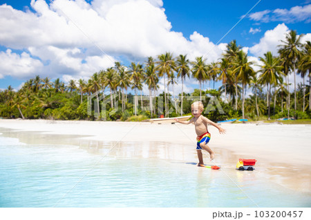 Kids play on tropical beach. Sand and water toy. Kids play on tropical beach. Sand and water toy. 103200457