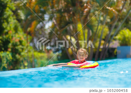 Child in swimming pool on toy ring. Kids swim. Child in swimming pool on toy ring. Kids swim. 103200458