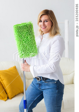 Portrait of housewife woman holds mop pad - cleaning concept 103200486