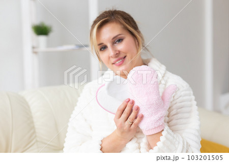Woman hand holding massage sponge - spa and body care concept Woman hand holding massage sponge - spa and body care concept 103201505