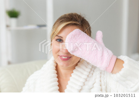 Woman hand holding massage sponge - spa and body care concept Woman hand holding massage sponge - spa and body care concept 103201511