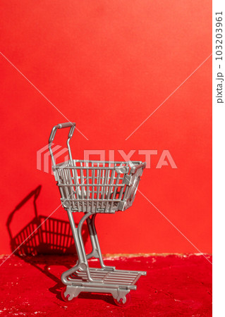 Supermarket cart on red background. Supermarket cart on red background. 103203961