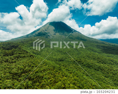 Amazing view of beautiful Arenal volcano in Costa Rica. Panorama of volcano Arenal reflected on wonderful picturesque lake, La Fortuna, Costa Rica. Central America. 103204231