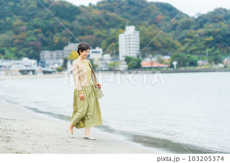 海辺を歩くミドルの女性 103205374