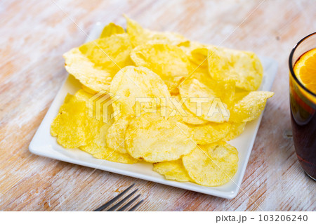 Glass of fortified vermouth traditionally garnished with orange wedges served with Spanish tapas 103206240