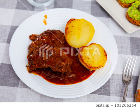 Fried pork cheek served on dish with potatoes Fried pork cheek served on dish with potatoes 103206254
