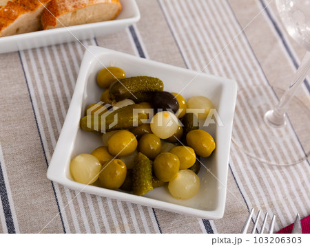 Green olives served with cucumber and onion on plate Green olives served with cucumber and onion on plate 103206303