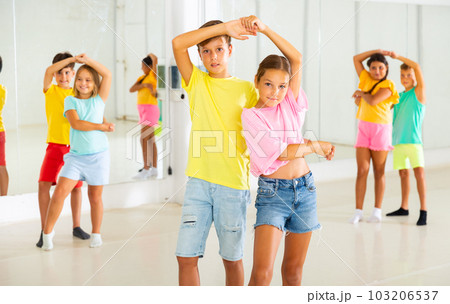 Boys and girls enjoying active dance in studio 103206537
