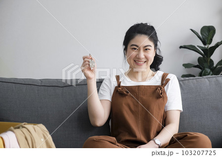 Woman owner buy purchase home, relocate to dwelling, rental, rent, ownership concept Woman owner buy purchase home, relocate to dwelling, rental, rent, ownership concept 103207725