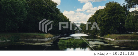 Baths classicist Palace on the Isle in Lazienki Park touristic place in Warsaw. Lazienki Royal Baths Park, Baroque columns Warsaw Poland. Mirror Reflection on the Lake 103211132