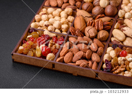 Mix of roasted macadamia nuts, cashews, pecans, almonds, raisins and dry berries 103212933