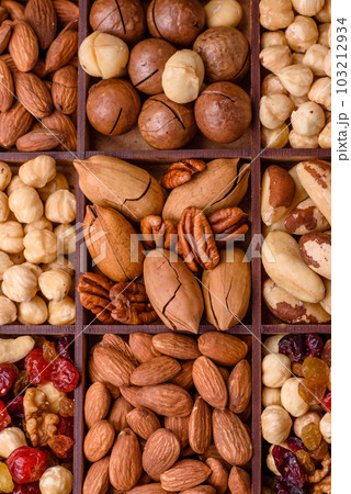 Mix of roasted macadamia nuts, cashews, pecans, almonds, raisins and dry berries 103212934