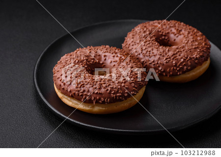 Delicious chocolate glazed donut sprinkled with chocolate chips 103212988