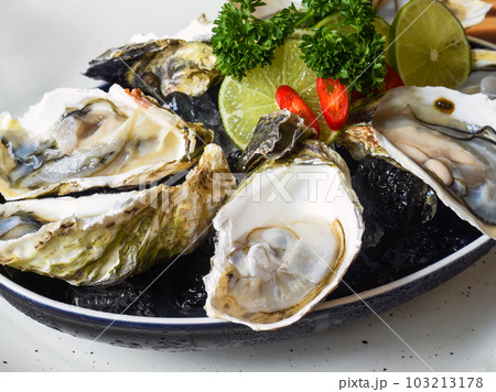 Raw oysters in creamy served with sauces close up 103213178