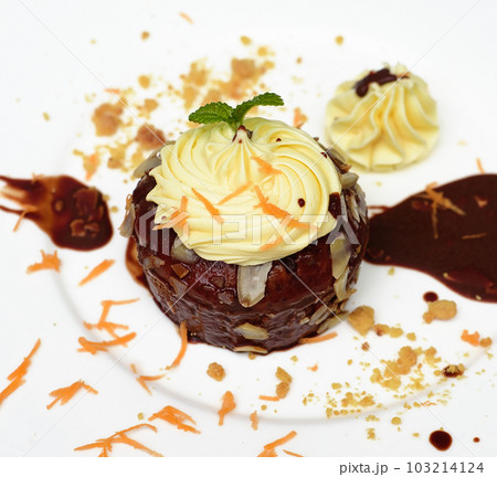 Carrot chocolate cake on plate and black background Carrot chocolate cake on plate and black background 103214124