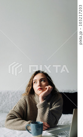 Creative woman working from home writing lesson plan and schedule for students, using laptop and Creative woman working from home writing lesson plan and schedule for students, using laptop and 103217203