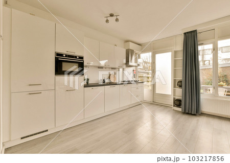 a kitchen with white cupboards and appliances on the counter top in front of the oven, sink and dishwasher a kitchen with white cupboards and appliances on the counter top in front of the oven, sink and dishwasher 103217856