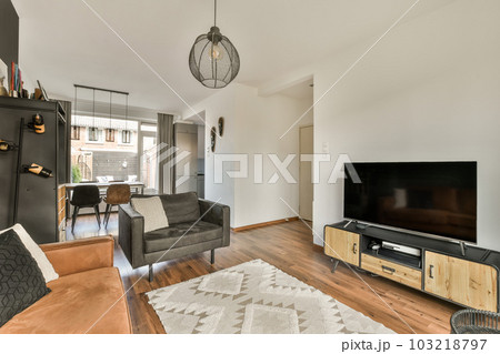 a living room with couches and a television set on the wall in front of the flat screen tv that is mounted above the 103218797