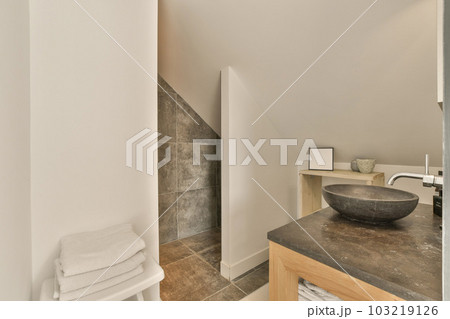 a bathroom with a sink, mirror and toilet paper on the counter in the photo is taken to the right a bathroom with a sink, mirror and toilet paper on the counter in the photo is taken to the right 103219126