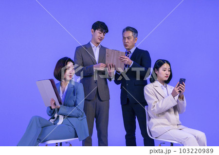 Asian Korean senior, middle aged and young male and female colleagues models in business attire, neon purple studio background, working Asian Korean senior, middle aged and young male and female colleagues models in business attire, neon purple studio background, working 103220989