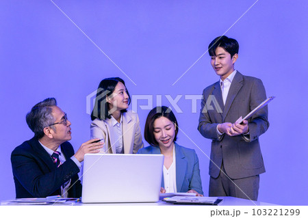 Asian Korean senior, middle aged and young male and female colleagues models in business attire, neon purple studio background, explain documents Asian Korean senior, middle aged and young male and female colleagues models in business attire, neon purple studio background, explain documents 103221299