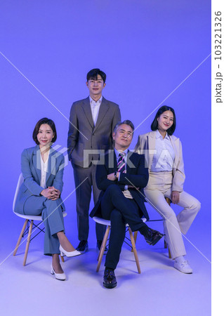 Asian Korean senior, middle aged and young male and female colleagues models in business attire, neon purple studio background, look straight ahead Asian Korean senior, middle aged and young male and female colleagues models in business attire, neon purple studio background, look straight ahead 103221326
