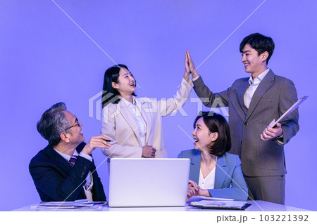 Asian Korean senior, middle aged and young male and female colleagues models in business attire, neon purple studio background, hand motion 103221392