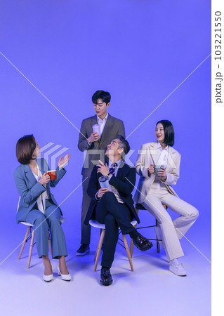 Asian Korean senior, middle aged and young male and female colleagues models in business attire, neon purple studio background, have a chat with coffee 103221550