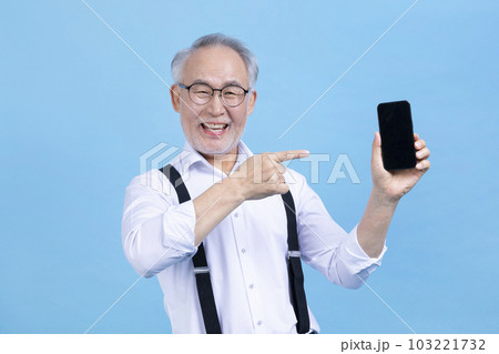 active young senior Korean Asian male holding headset active young senior Korean Asian male holding headset 103221732