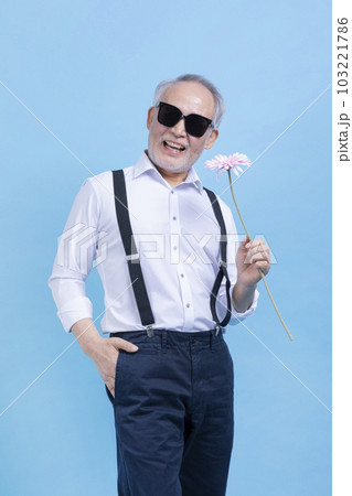 happy active young senior Korean Asian male holding flowers 103221786