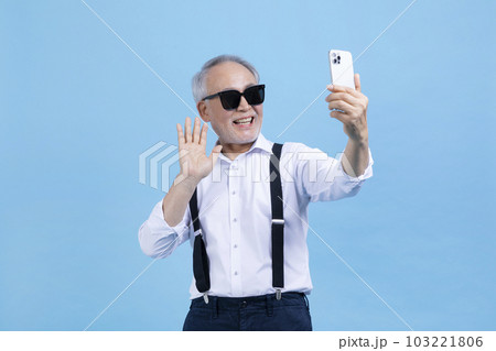 active young senior Korean Asian male on video chat, call 103221806