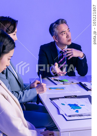 Asian Korean senior, middle aged and young male and female colleagues models in business attire, neon purple studio background, nagging at the employees 103221807