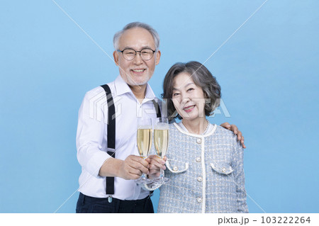 active young senior Korean Asian couple holding champagne glasses 103222264
