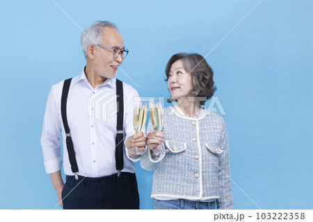 active young senior Korean Asian couple holding champagne glasses active young senior Korean Asian couple holding champagne glasses 103222358