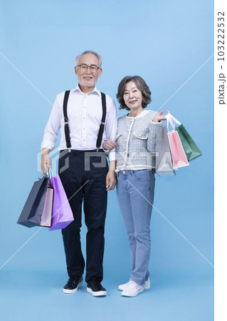 active young senior Korean Asian couple holding shopping bags active young senior Korean Asian couple holding shopping bags 103222532