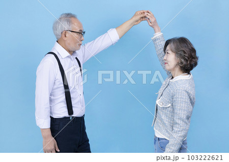 dancing active young senior Korean Asian couple, studio background dancing active young senior Korean Asian couple, studio background 103222621