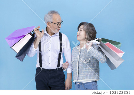 active young senior Korean Asian couple holding shopping bags active young senior Korean Asian couple holding shopping bags 103222853