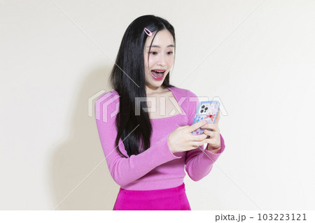 vintage y2k pink retro concept photo of korean asian cute woman holding a smartphone 103223121