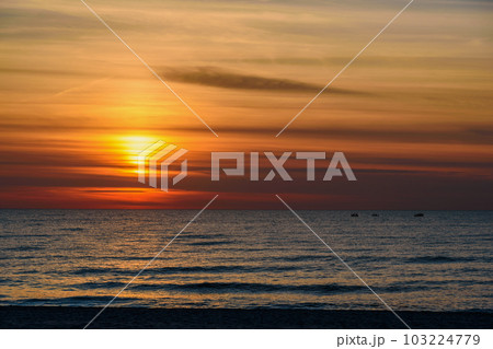 Spectacular bright golden sunset over Baltic sea 103224779
