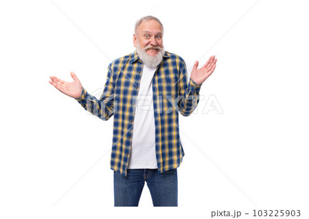 senior gray-haired retired man with a mustache and beard spreads his arms with his index finger and 103225903