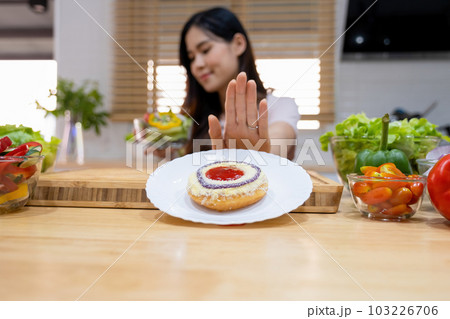 Woman rejecting junk food. Woman rejecting junk food. 103226706