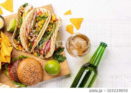 Mexican food featuring tacos, burritos, nachos, burgers Mexican food featuring tacos, burritos, nachos, burgers 103229650