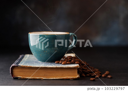 Rich coffee in a cup with aromatic roasted beans 103229797