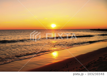 Sunset. Sunrise. Sunset on the shore of the beach with the sea calm and soft waves. Tranquility concept. 103230348