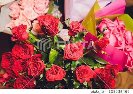 A flower bouquet with a lot of a different flowers. 103232463