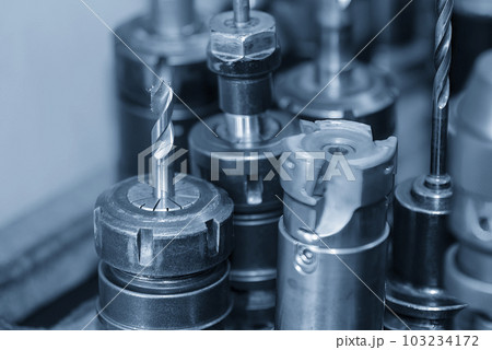 The group of various size of drill tools in the holder with light blue scene. 103234172